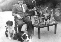 Christy Butler with Trial trophies and dogs