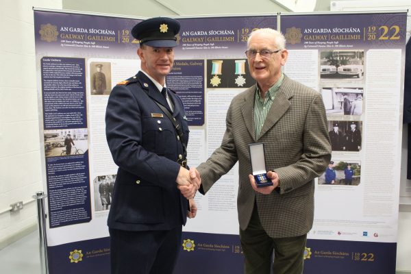 Retired Sergeant Joe Boyce receiving his centenary medal from Superintendent Damien Flanagan