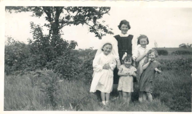 Barbara Welby in the pinafore with children unknown