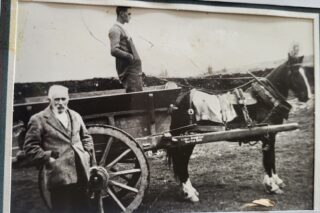 1000038335 Dermot's grandfather John Walsh, uncle Willie Walsh and horse 'Ashtown' returning to Bridge St after returning a coffin to Rosscahill circa. 1936 | D. Walsh